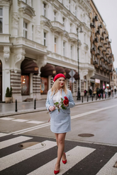 a lady in a white shirt, a blue jacket and a blue skirt